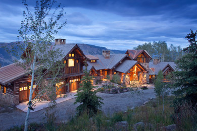Example of a mountain style two-story wood gable roof design in Denver