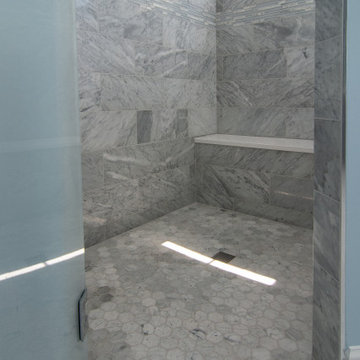 Traditional master bath utilizing frosted and clear glass to allow for needed pr
