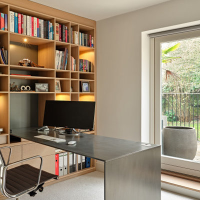 Small trendy built-in desk carpeted and beige floor study room photo in Surrey with no fireplace