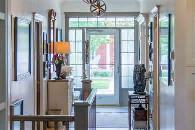 Entryway - mid-sized contemporary light wood floor entryway idea in Toronto with white walls and a white front door