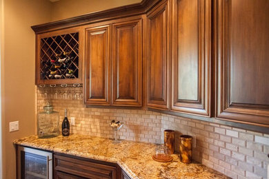 Transitional kitchen in Phoenix with raised-panel cabinets, medium wood cabinets, granite benchtops, beige splashback and stone tile splashback.