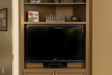 Elegant carpeted family room photo in Other with a media wall