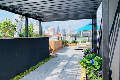 Inspiration for a mid-sized concrete paver patio remodel in New York with a pergola