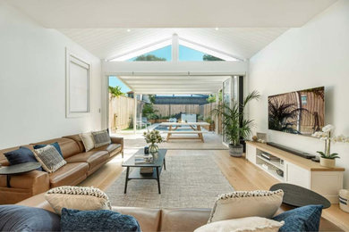 Example of a beach style living room design in Sydney