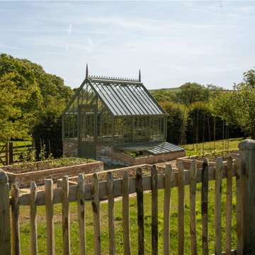 National Trust greenhouse in a garden by Darren Hawkes
