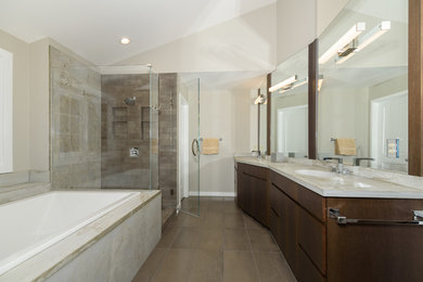 Mid-sized contemporary master bathroom in Cincinnati with flat-panel cabinets, medium wood cabinets, a drop-in tub, a corner shower, a two-piece toilet, gray tile, marble, grey walls, marble floors, an integrated sink, concrete benchtops, brown floor and a hinged shower door.