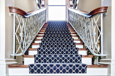 Large elegant wooden straight staircase photo in Louisville with painted risers