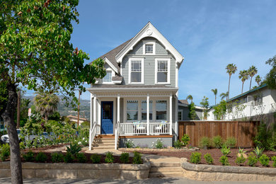 Photo of a small beach style two-storey grey house exterior in Santa Barbara with wood siding, a gable roof and a shingle roof.