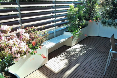 Design ideas for an expansive contemporary rooftop deck in Milan with a container garden and an awning.