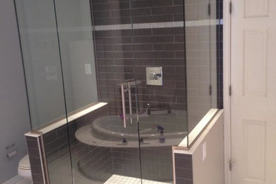 Mid-sized trendy master gray tile and porcelain tile ceramic tile and white floor bathroom photo in Minneapolis with a one-piece toilet, gray walls and a hinged shower door