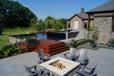 Photo of an expansive modern infinity pool in Cleveland with a hot tub.
