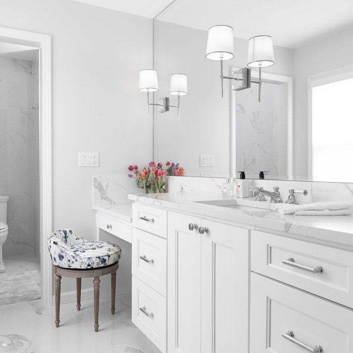 The master vanity of Engineered Quartz is elegant and durable, large enough to display personal items and still drops down to a seated vanity. Visual Comfort Wall Sconces on the full mirror accentual