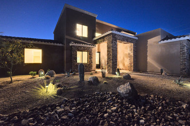 This is an example of a mediterranean two-storey stucco beige exterior in Phoenix.