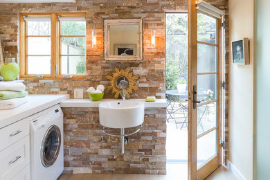 This is an example of a transitional l-shaped utility room in San Francisco with a single-bowl sink, recessed-panel cabinets, white cabinets, beige walls, light hardwood floors and a side-by-side washer and dryer.