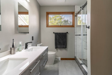 Inspiration for a mid-sized contemporary master vinyl floor, gray floor and double-sink alcove shower remodel in Cleveland with flat-panel cabinets, gray cabinets, a one-piece toilet, gray walls, quartz countertops, white countertops and a floating vanity
