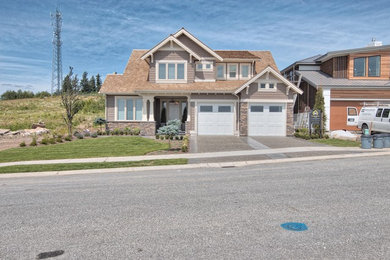 Example of a large trendy brown three-story concrete fiberboard gable roof design in Vancouver