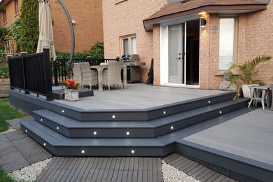 Deck - mid-sized modern backyard deck idea in Toronto with no cover