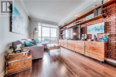 Small urban open concept laminate floor and brown floor living room photo in Toronto with gray walls and a media wall