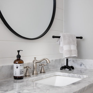 Marble Vanity Detail with Undermount Sink and Black Mirror