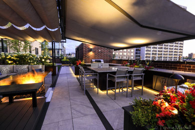Large contemporary rooftop deck in Chicago with an outdoor kitchen and a pergola.