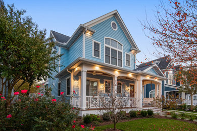 Example of a beach style blue two-story house exterior design in Other