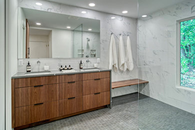 Inspiration for a mid-sized contemporary master white tile and porcelain tile porcelain tile, black floor, double-sink and wallpaper bathroom remodel in Minneapolis with flat-panel cabinets, medium tone wood cabinets, a one-piece toilet, white walls, an undermount sink, quartz countertops, gray countertops and a built-in vanity