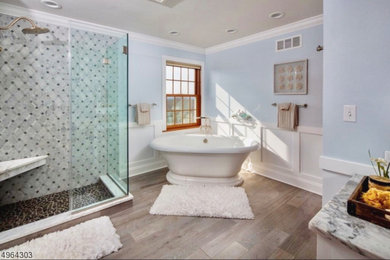 Inspiration for a french country porcelain tile, gray floor, double-sink and wainscoting bathroom remodel in New York with beaded inset cabinets, blue walls, a hinged shower door and a built-in vanity