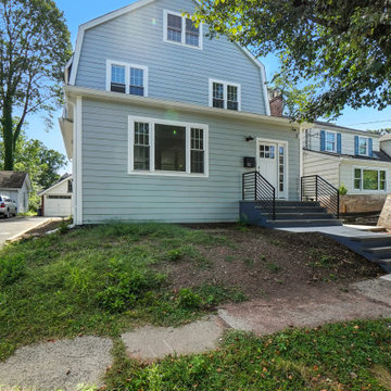 Gambrel Roof Exterior with Modern Metal Railing