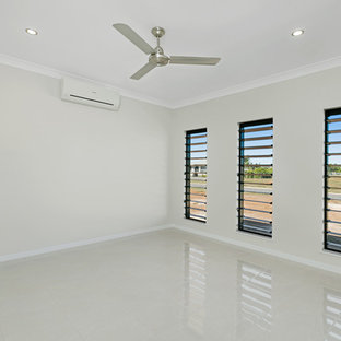 Inspiration for a mid-sized modern enclosed ceramic floor home theater remodel in Cairns with beige walls