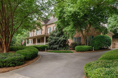 Example of a classic brick exterior home design in Raleigh