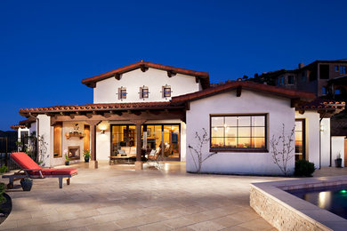 Design ideas for a large traditional two-storey adobe white exterior in San Diego with a tile roof.