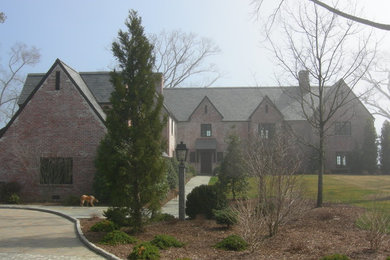 Example of a classic brown brick exterior home design in New York