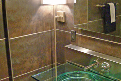 Example of a small trendy 3/4 brown tile and porcelain tile porcelain tile alcove shower design in Other with an integrated sink, open cabinets, glass countertops, brown walls and a one-piece toilet