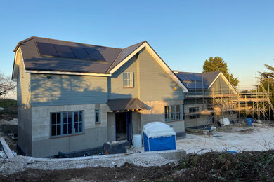 This is an example of a medium sized and blue country two floor detached house in Kent with mixed cladding, a pitched roof and a tiled roof.