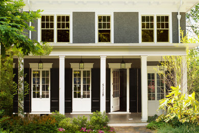 This is an example of a large traditional brick front porch design in DC Metro.