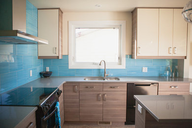 Enclosed kitchen - mid-sized contemporary l-shaped porcelain tile enclosed kitchen idea in Calgary with an undermount sink, flat-panel cabinets, white cabinets, quartz countertops, blue backsplash, ceramic backsplash, black appliances and an island