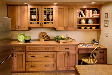 Inspiration for a mid-sized arts and crafts u-shaped eat-in kitchen in Milwaukee with a double-bowl sink, shaker cabinets, medium wood cabinets, wood benchtops, stainless steel appliances, porcelain floors and with island.