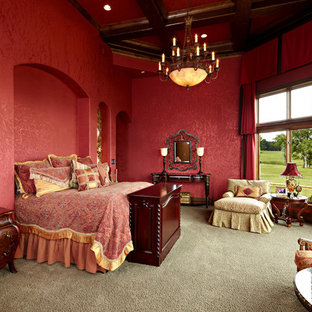 Large mediterranean master bedroom in New Orleans with red walls, carpet and no fireplace.