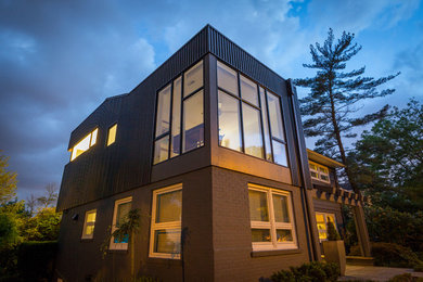 This is an example of a modern two-storey grey exterior in Cincinnati with metal siding.