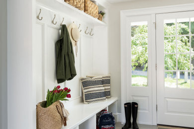 Example of a classic ceramic tile and gray floor entryway design in Boston with white walls