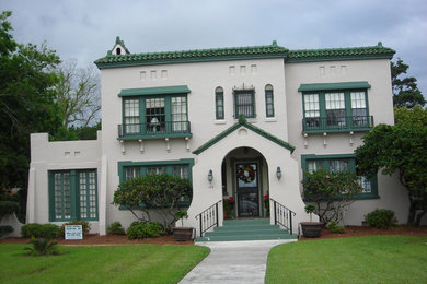 Example of a large tuscan beige two-story stucco exterior home design in Jacksonville with a hip roof