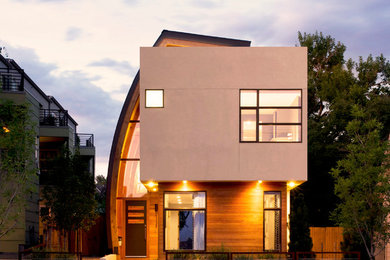 Photo of a mid-sized contemporary two-storey beige exterior in Denver with wood siding.