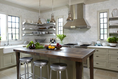 Trendy l-shaped travertine floor eat-in kitchen photo in Miami with recessed-panel cabinets, beige cabinets, wood countertops, white backsplash, ceramic backsplash and an island