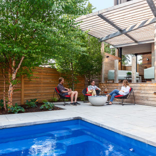 Inspiration for a modern partial sun backyard concrete paver and wood fence landscaping in Toronto for summer.