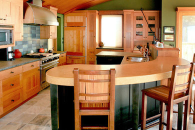 Example of a trendy u-shaped travertine floor open concept kitchen design in San Francisco with an undermount sink, shaker cabinets, medium tone wood cabinets, granite countertops, multicolored backsplash, porcelain backsplash, paneled appliances and an island