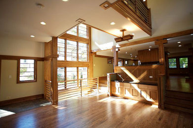 This is an example of a large traditional loft-style living room in Chicago with beige walls, medium hardwood floors and brown floor.