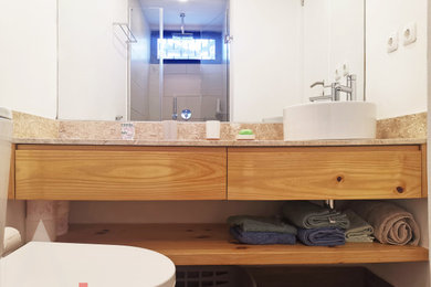 Example of a small trendy porcelain tile and brown floor bathroom design in Other with a one-piece toilet and white walls