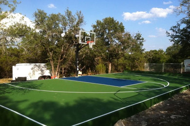 Photo of a large traditional partial sun backyard concrete paver landscaping in Austin for summer.