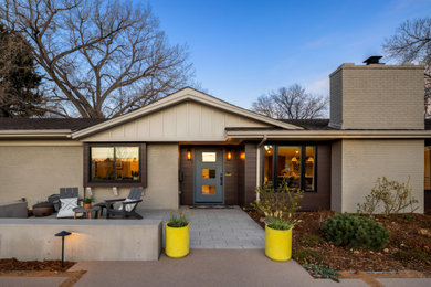 Example of a huge transitional gray one-story metal house exterior design in Denver with a shingle roof and a black roof