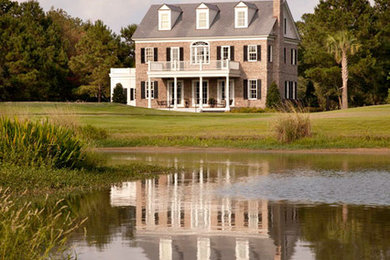 Example of a large classic three-story brick exterior home design in Atlanta